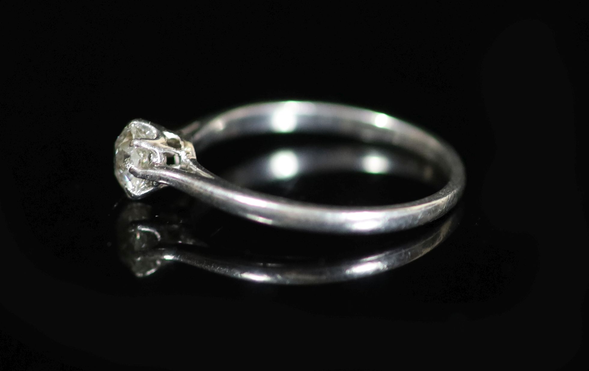 A platinum and diamond solitaire ring, the claw-set circular brilliant cut diamond approximately 0.5ct